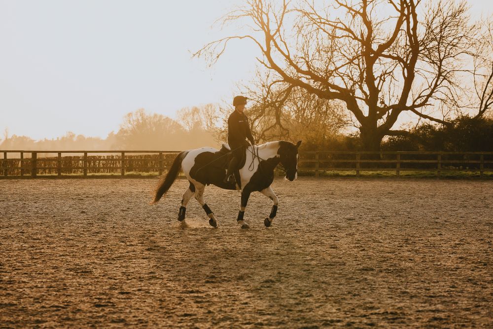 Student riding a horse.