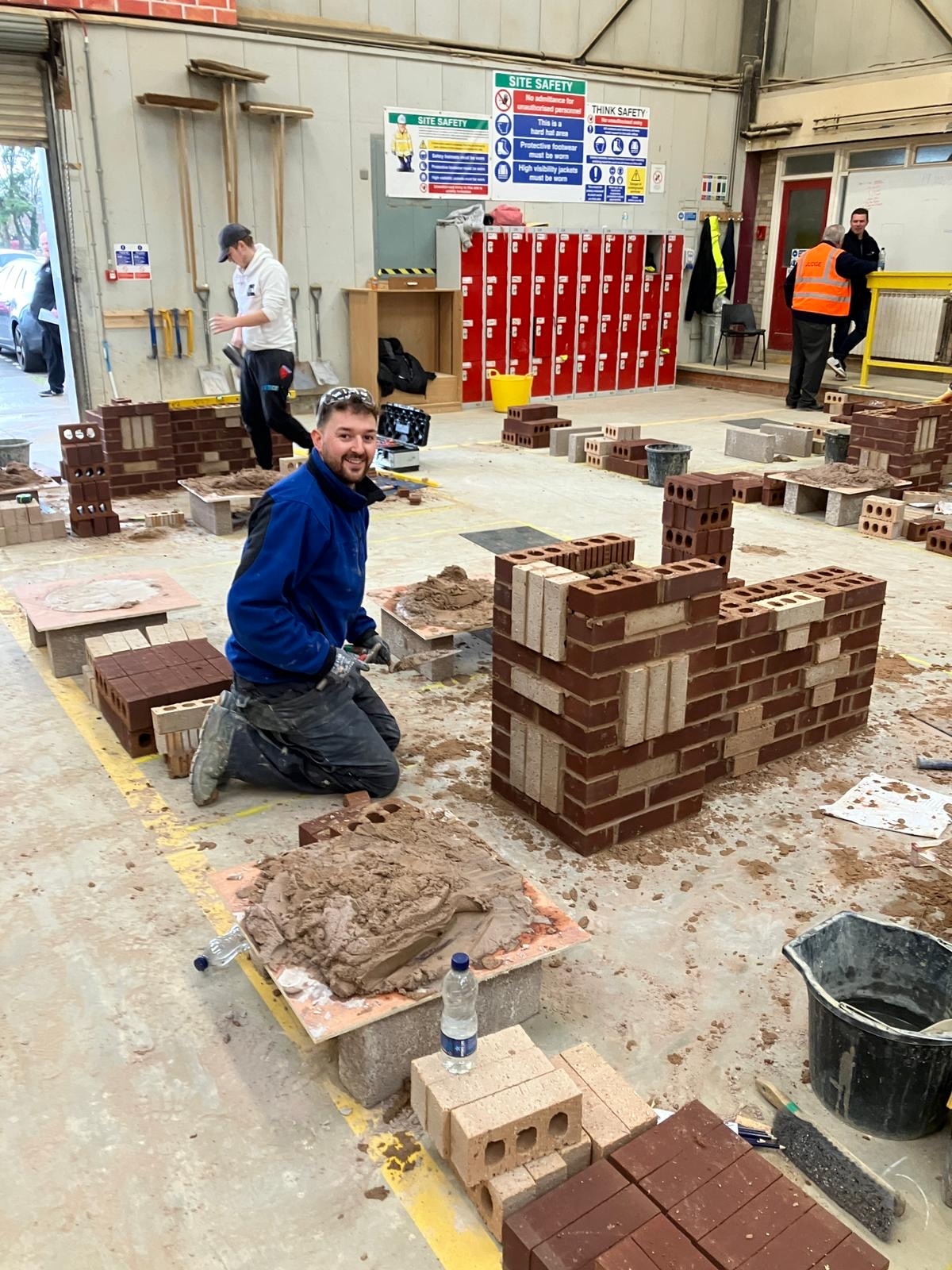 Liam showing his bricklaying accomplishment. 